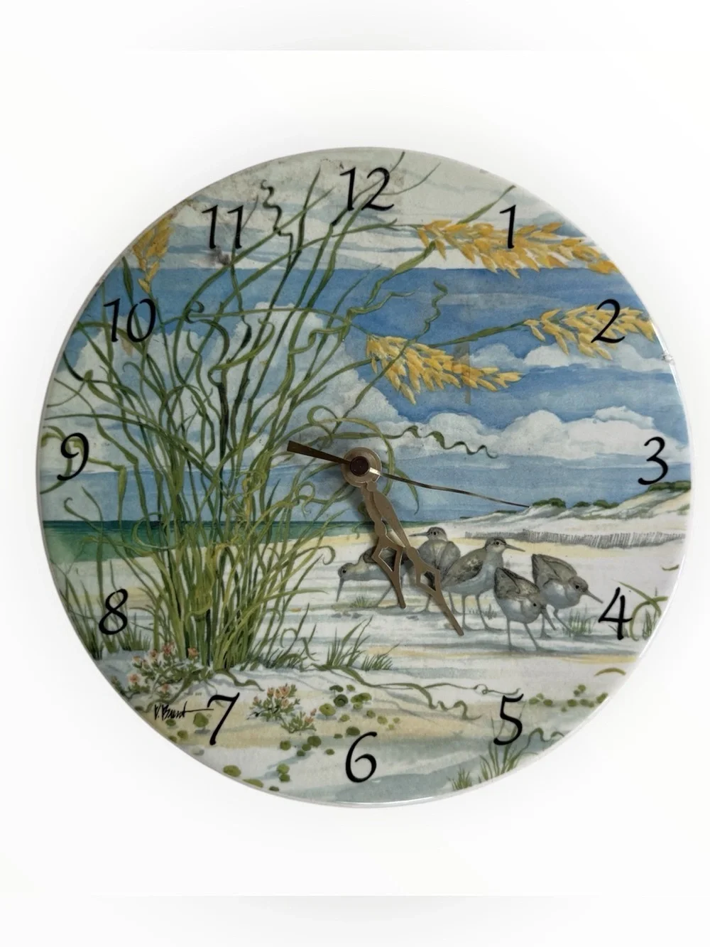 watercolor-style beach scene with shorebirds and dune grass ceramic clock